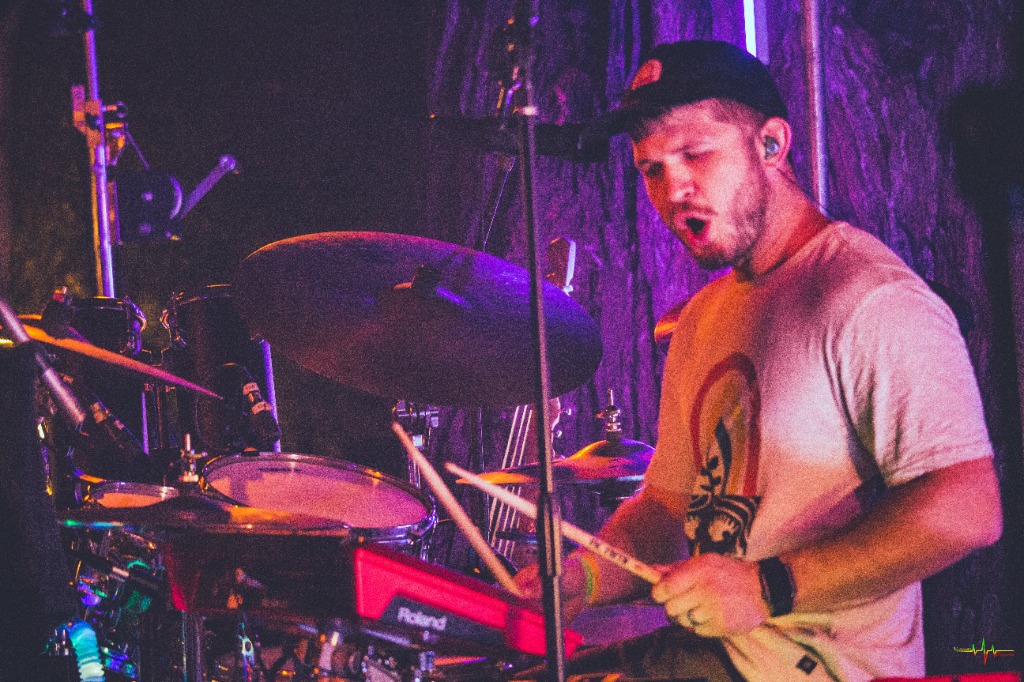 Live drummer performance with hybrid acoustic kit and Roland percussion electronics.